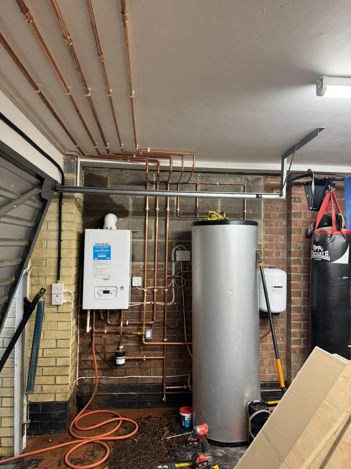 Boiler and unvented cylinder installed side by side with copper pipework and controls
