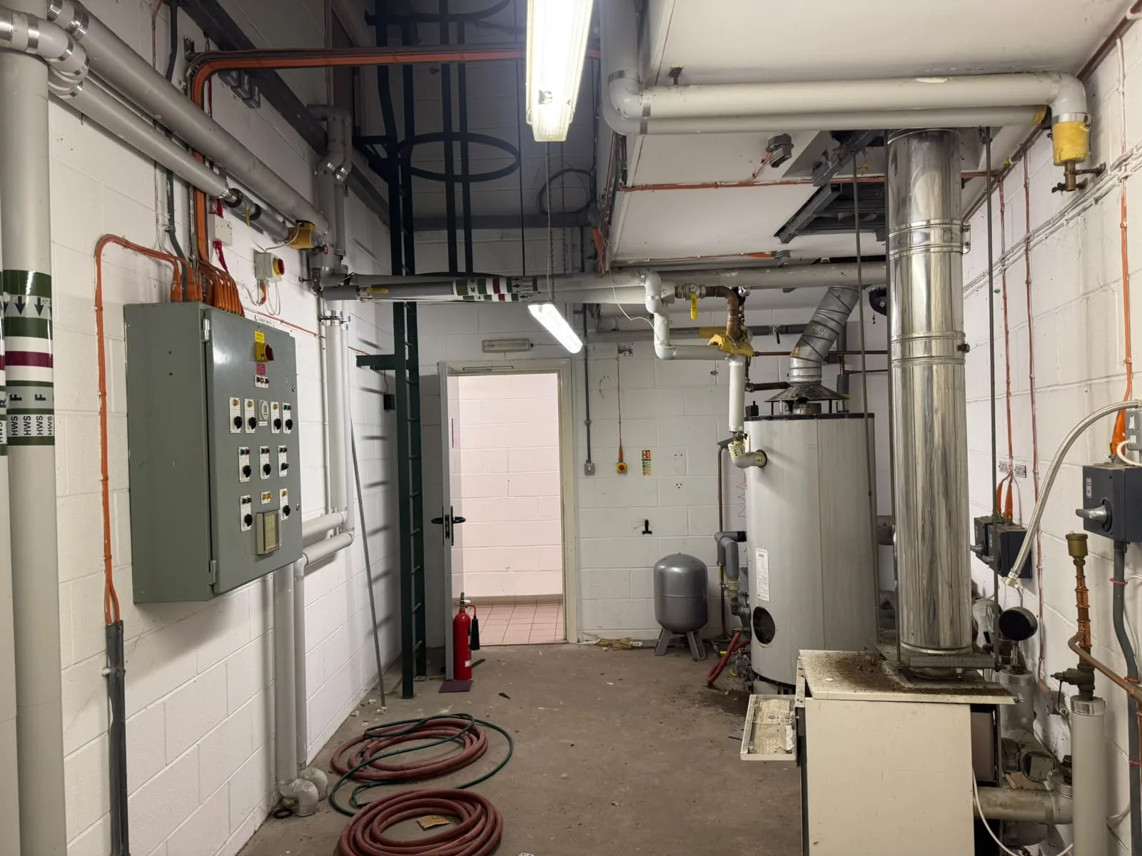 Commercial plant room with boiler, flue and wall mounted control panel