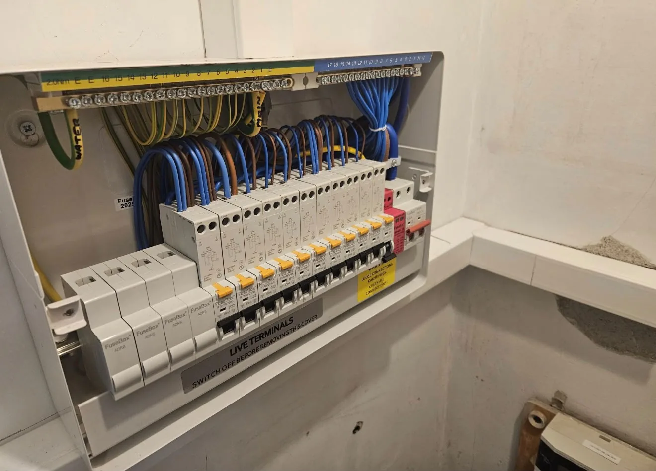 New consumer unit with a full row of RCBOs and neatly loomed cabling