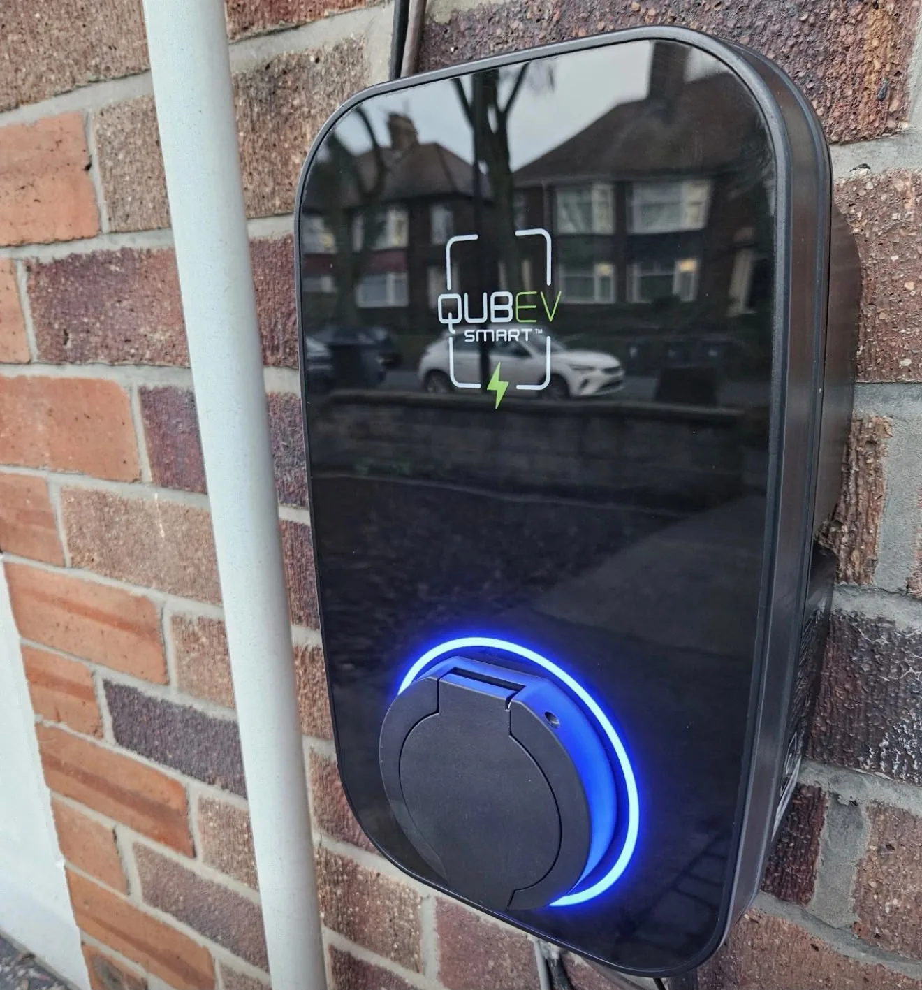 QubEV smart EV charge point installed and powered up on a house wall