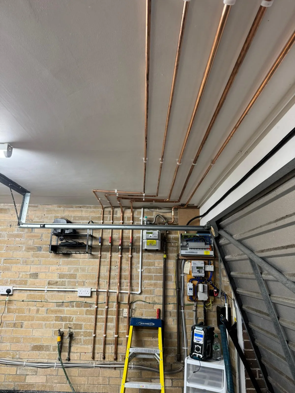 First fix copper heating pipework run across a garage ceiling before boarding