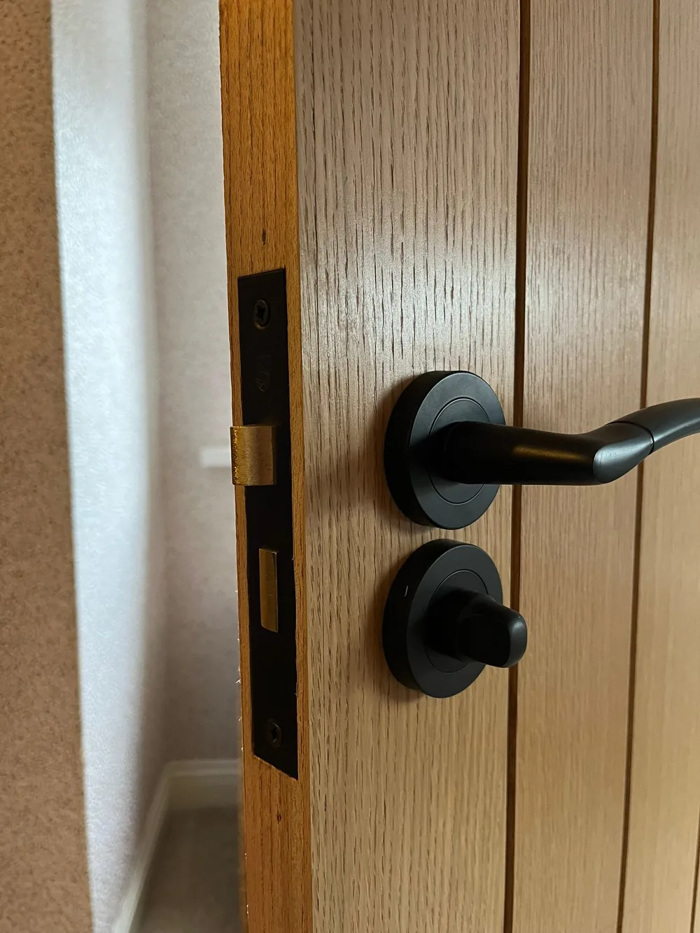 New internal door handle and lock fitted on an oak door