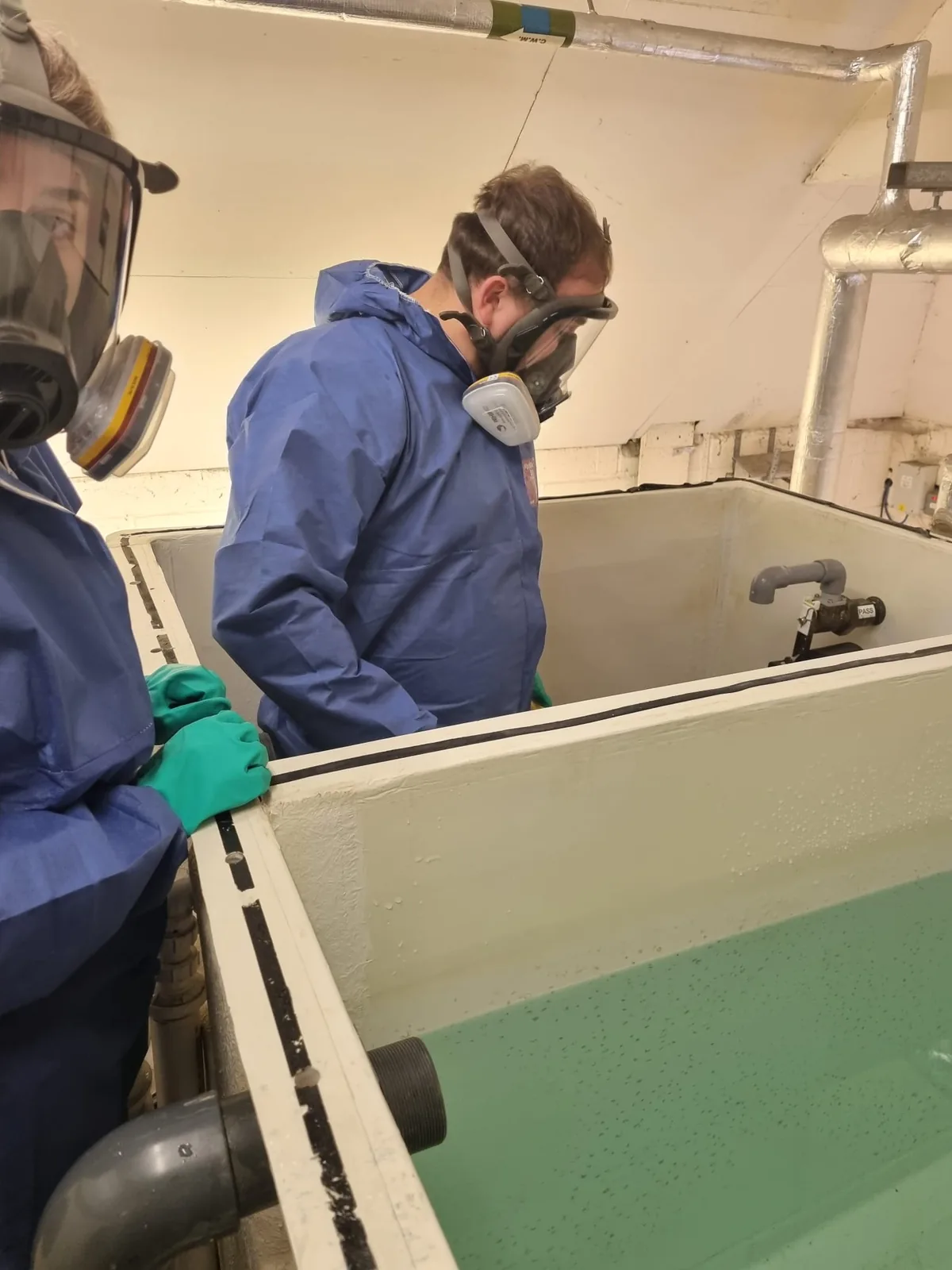 water-tank-cleaning-operatives-ppe-01 Operatives in full face respirators and PPE cleaning a cold water storage tank